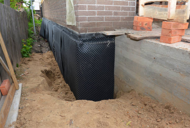 Happy homeowners after waterproofing job in Irons
